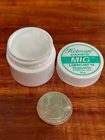 My personal jar of MIG (Musical Instrument Grease) lubricant that I purchased. Opened with a USA quarter next to it to show the size of the jar and how little I've used in 4 years (jar is almost full)