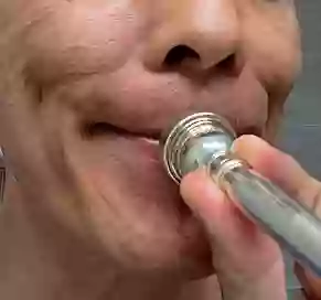 Incorrect Smile embouchure lip buzzing a trumpet mouthpiece.